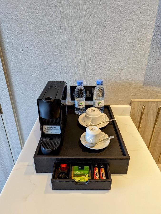 Citadines Abha Aparthotel Exterior foto A Nespresso coffee machine in a hotel room